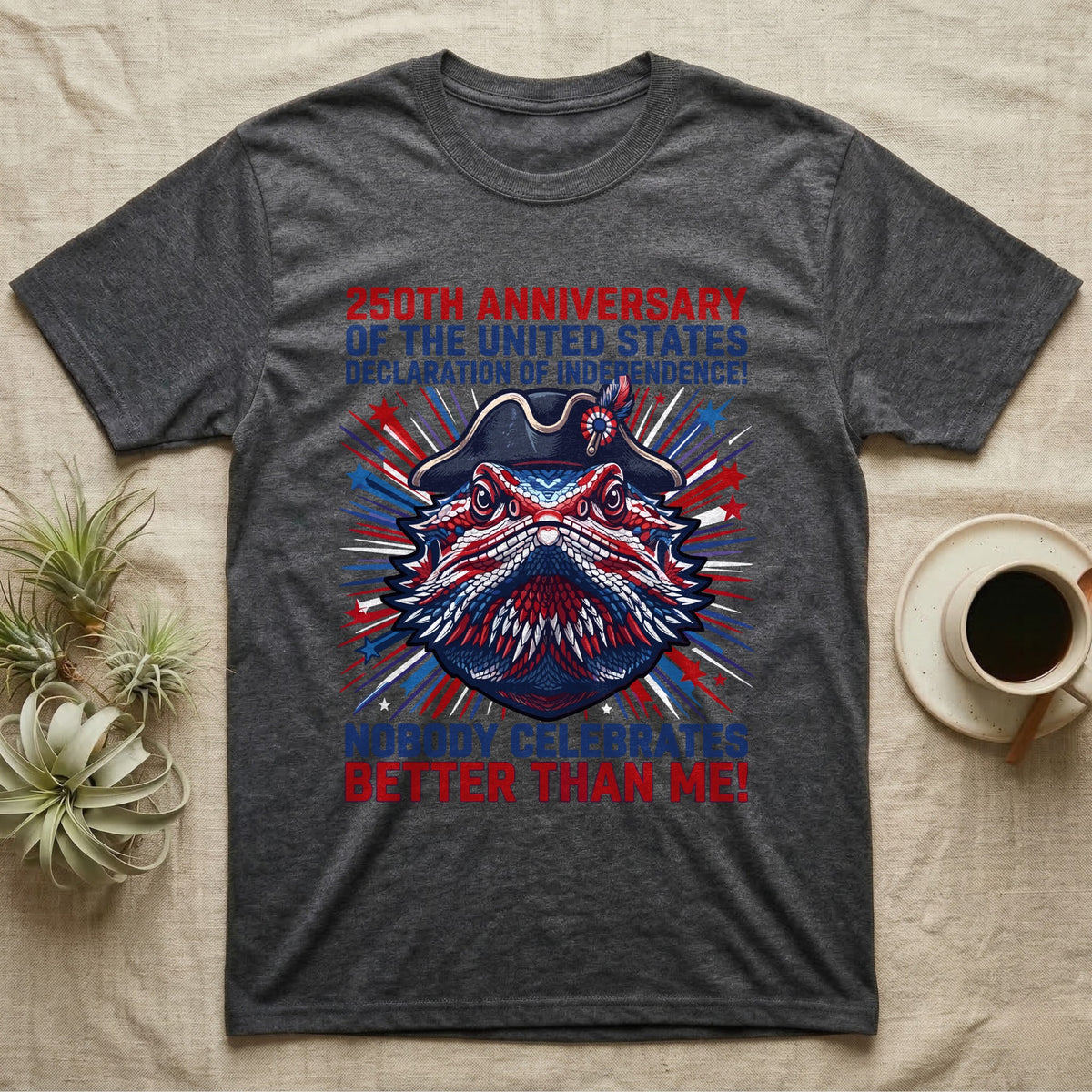 Bearded Dragon Fireworks T-Shirt in Dark Heather — Pop-art bearded dragon head in a tricorn hat amid red-white-blue fireworks under Nobody Celebrates Better Than Me.