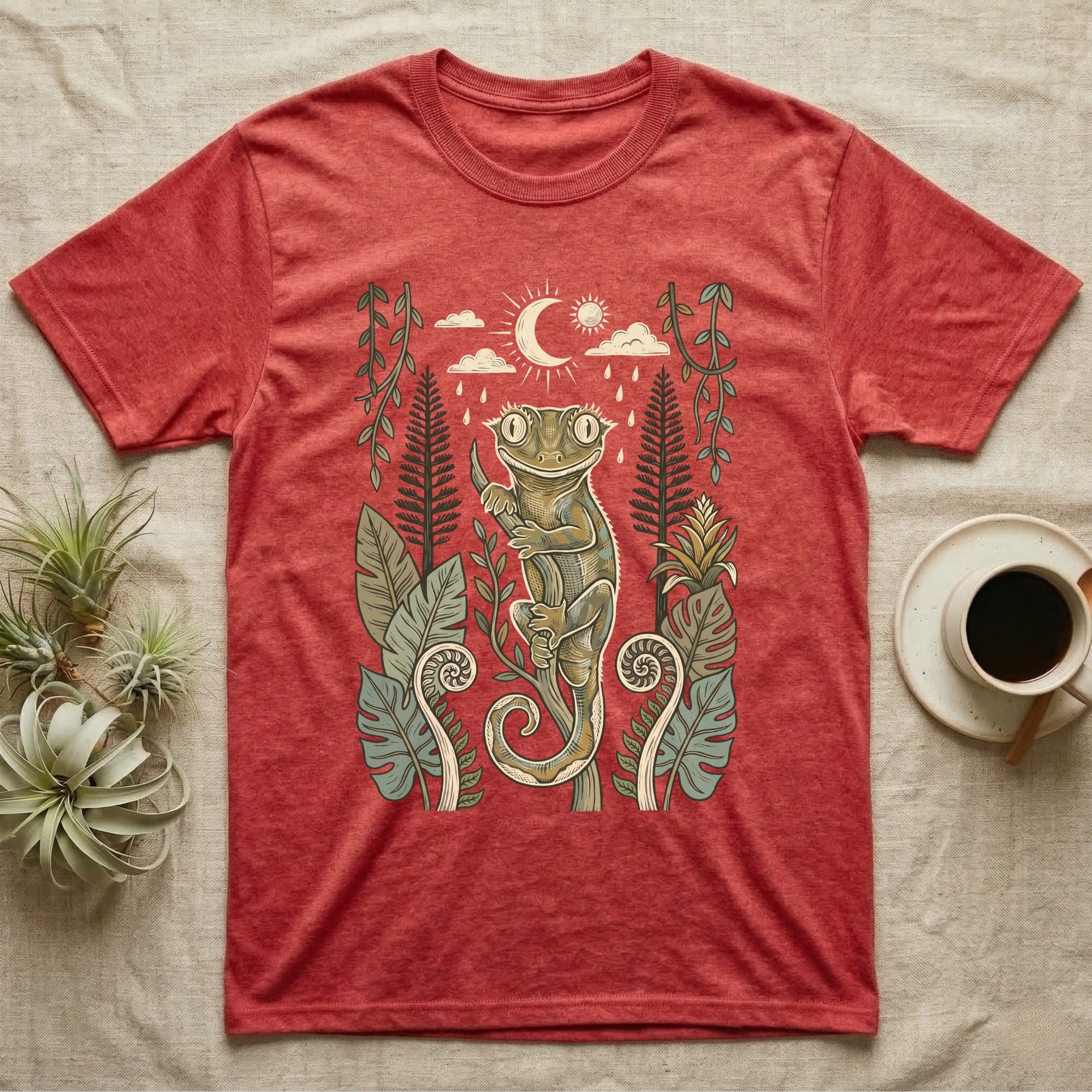 Crested Gecko Rainforest T-Shirt in Heather Red — Linocut-style crested gecko clinging to a branch under a crescent moon, framed by rainforest ferns, pines and leaves.