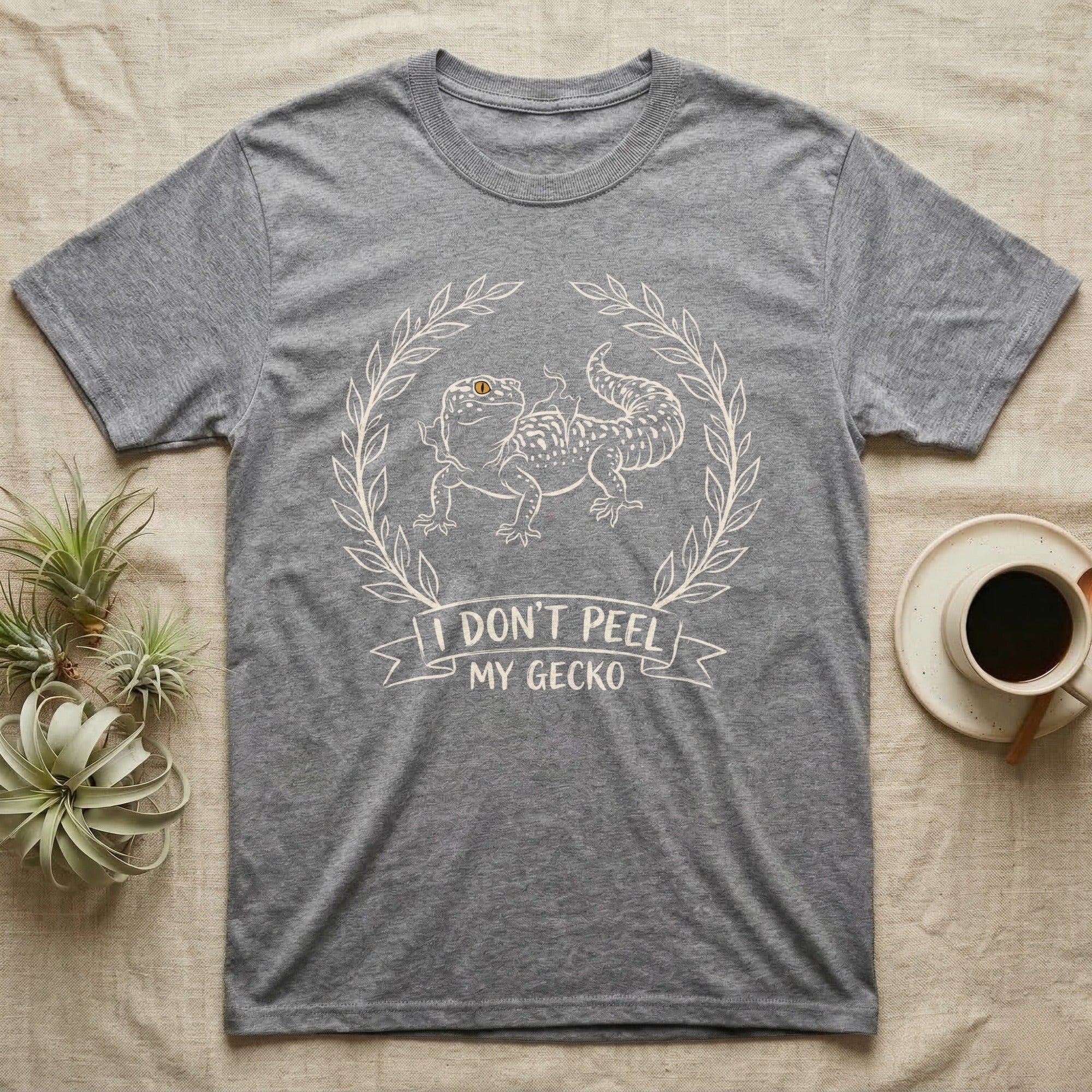 Leopard Gecko Shed T-Shirt in Sport Grey — Leopard gecko mid-shed in a cream brush-ink laurel crest with I DONT PEEL MY GECKO banner on grey