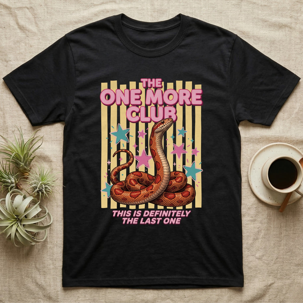 Corn Snake Club T-Shirt in Black — Engraved corn snake sitting deadpan under pink lettering The One More Club, with This is definitely the last one below, on yellow stripes