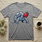 Sulcata Strawberry Tortoise T-Shirt in Sport Grey — Bold vector illustration of a sulcata tortoise lunging neck-first toward an oversized red strawberry, head-on view.