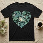 Black t-shirt with a heart-shaped design of monstera leaves and a frog.