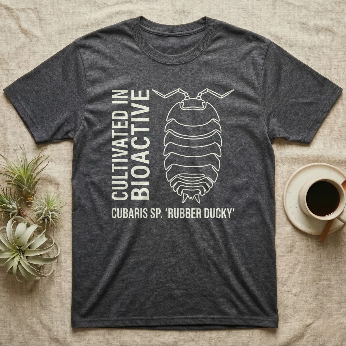 Rubber Ducky Isopod Line Art T-Shirt in Dark Heather — Bone-white outline drawing of a rubber ducky isopod labelled Cubaris sp. beside vertical stencil type.