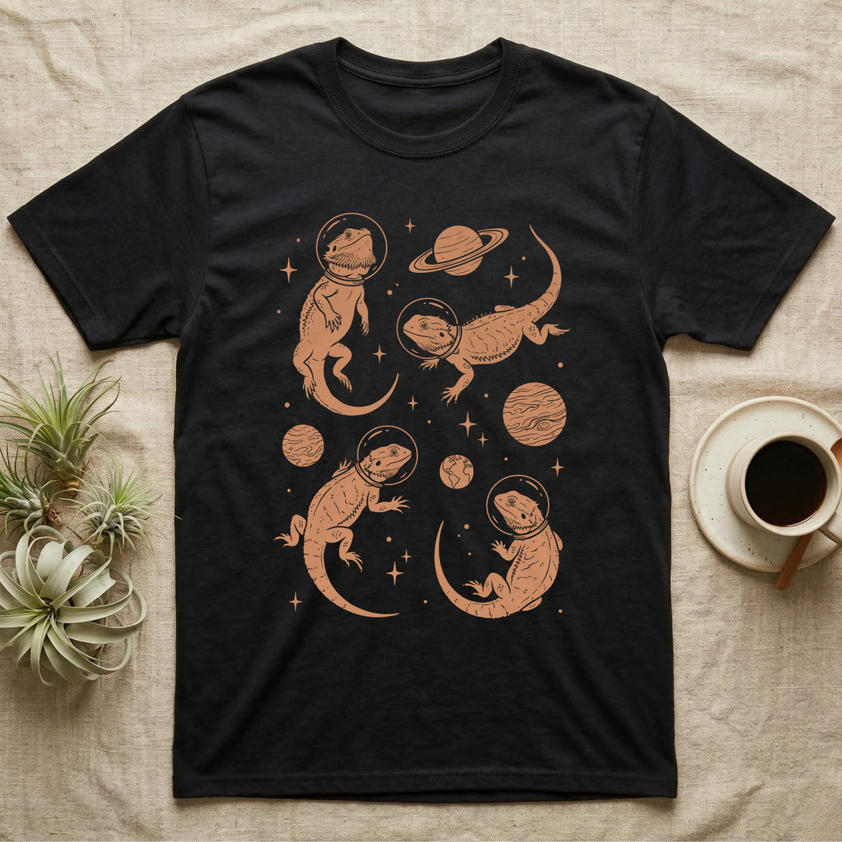 Bearded Dragon Cosmic T-Shirt in Black — Vintage screen-print illustration of bearded dragons in astronaut helmets floating in space, warm copper monochromatic on dark background.