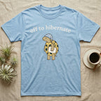 Hermann's Tortoise Hibernation T-Shirt in Light Blue — Minimal doodle of a Hermann's tortoise in a striped nightcap holding a pillow under the words off to hibernate
