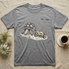 Tortoise Lawnmower Googly T-Shirt in Sport Grey — Linocut illustration of a sulcata tortoise grazing beside a push mower wearing oversized googly eyes.