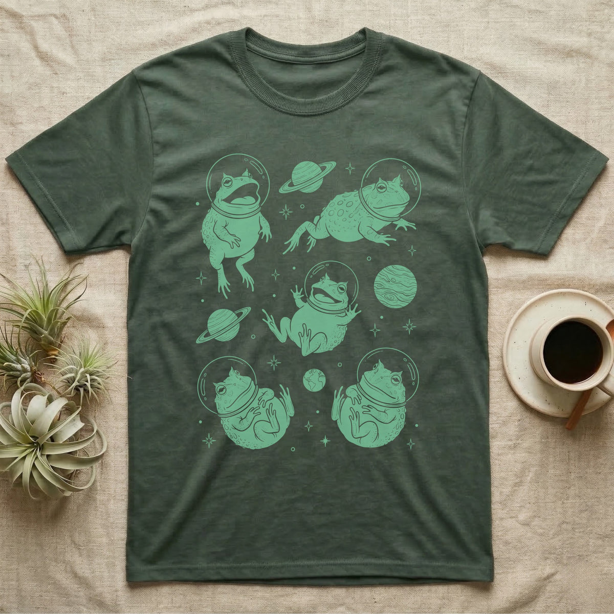 Pacman Frog Cosmic T-Shirt in Military Green — Vintage screen-print illustration of Pacman frogs in astronaut helmets floating in space, cosmic jade green monochromatic on dark background.