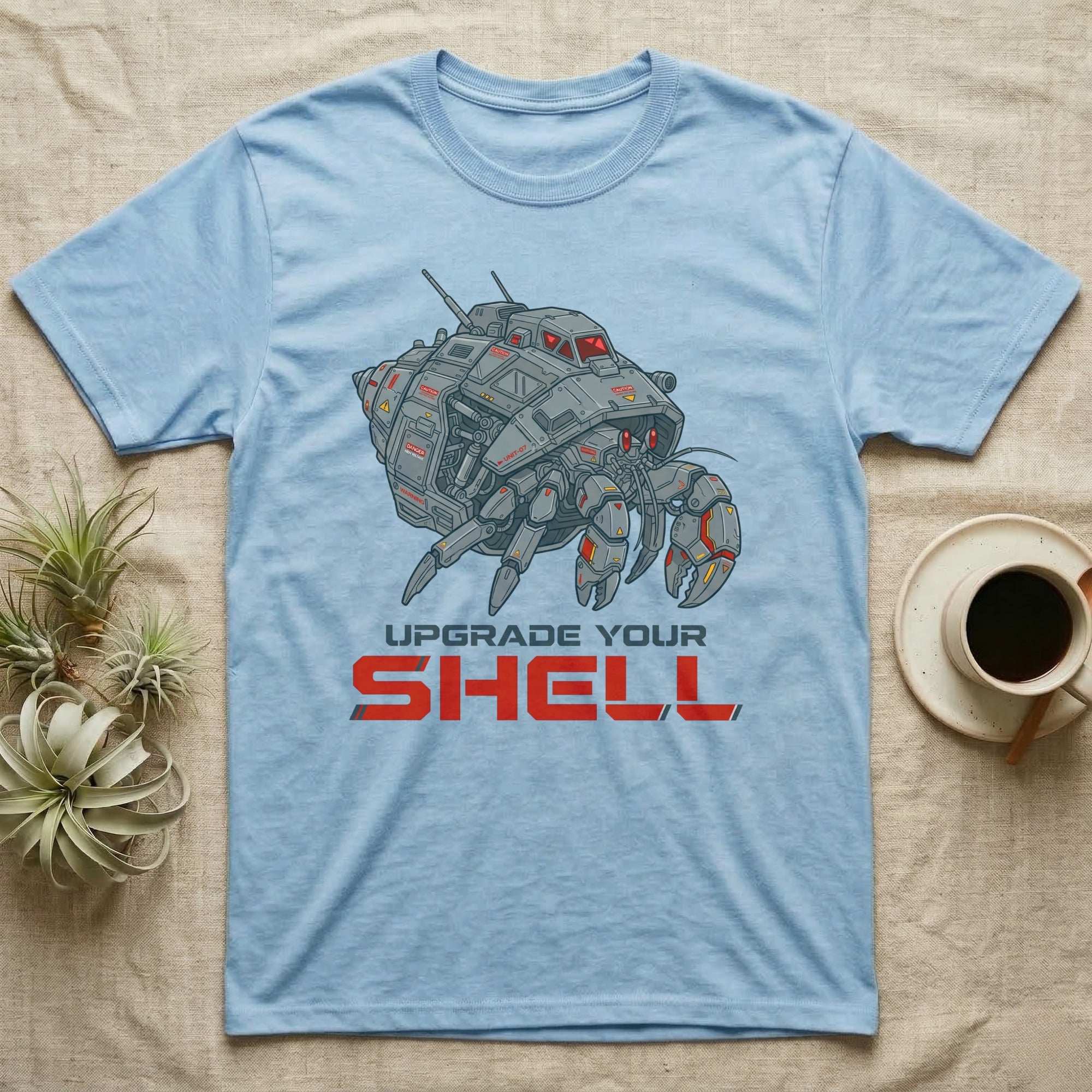Light blue t-shirt with a robotic hermit crab and "UPGRADE YOUR SHELL" text.