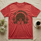 Sulcata Tortoise Under Lawn T-Shirt in Heather Red — Engraved sulcata tortoise in white line, head down and legs braced mid-dig, under retro script reading UNDER THE LAWN.
