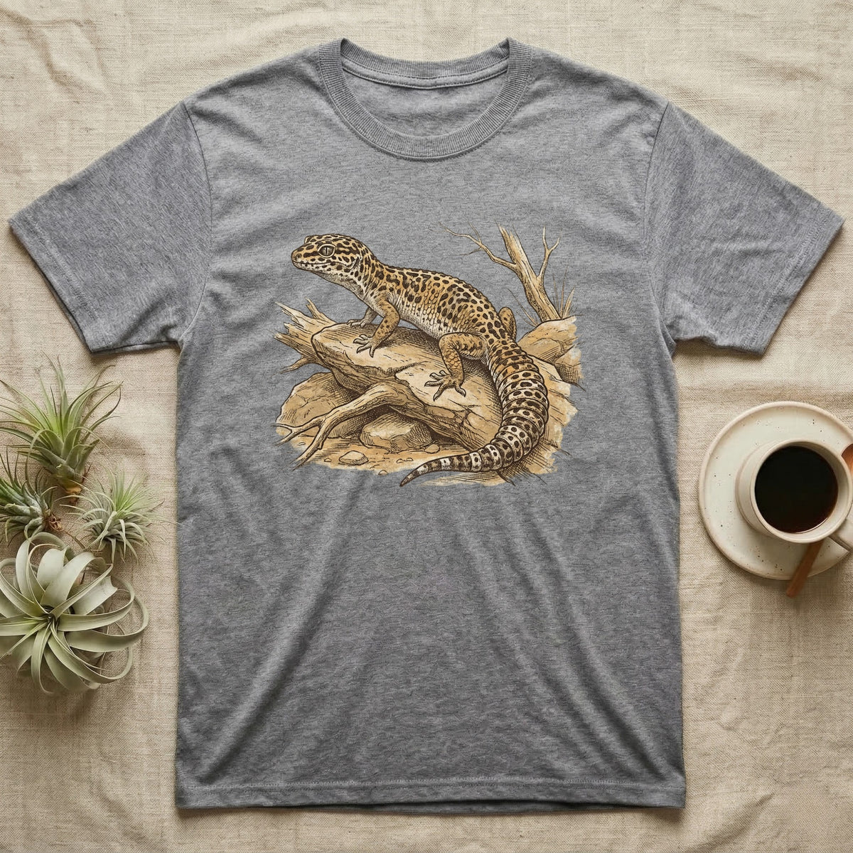 Grey t-shirt with a detailed illustration of a leopard gecko on a branch.