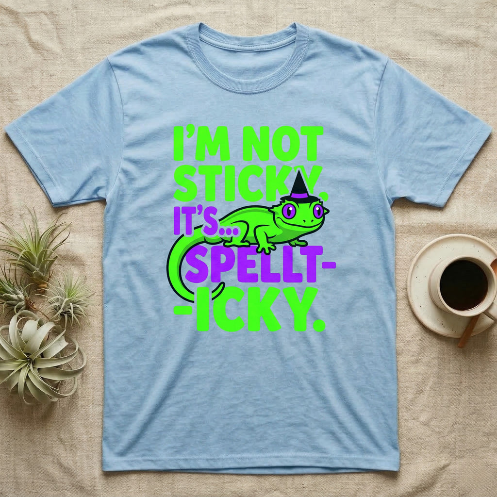 Crested Gecko Spellt-icky T-Shirt in Light Blue — Neon cartoon crested gecko in a witch hat with stacked text, "I'm Not Sticky, It's Spellt-icky."