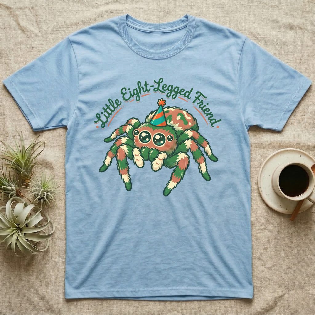 Light blue t-shirt with a cartoon jumping spider wearing a party hat.