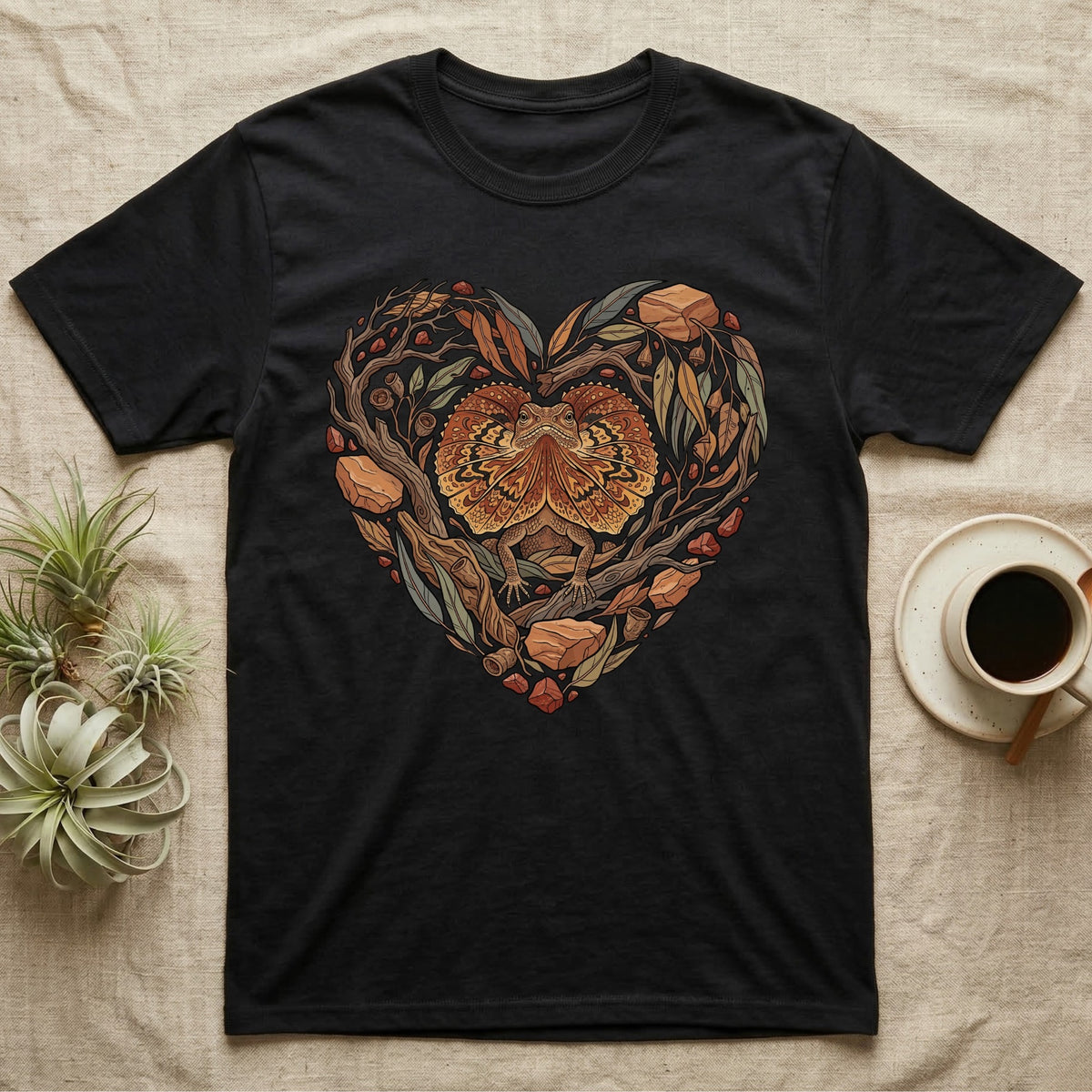 Black t-shirt featuring a heart design of a lizard surrounded by leaves and branches.