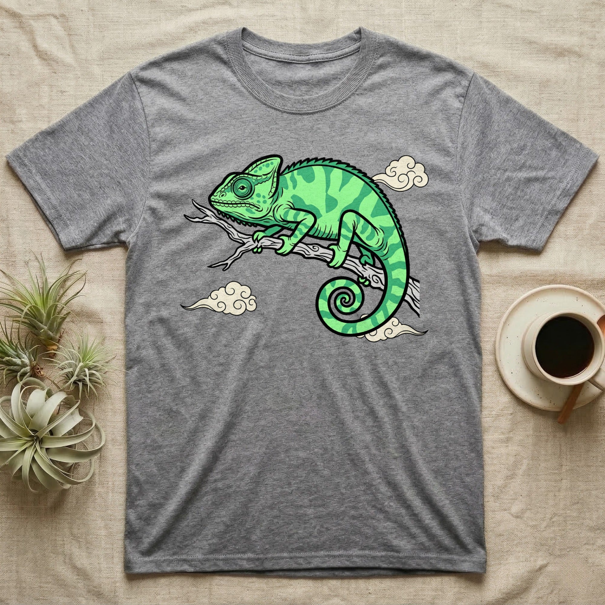 Gray t-shirt with a green chameleon on a branch with clouds.