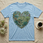 Light blue t-shirt with a heart-shaped design of a gecko amidst lush tropical foliage.