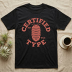 Isopod Certified Morph T-Shirt in Black — Carved block-print isopod seen from above inside a ring of terracotta lettering reading CERTIFIED NOT WILD TYPE.