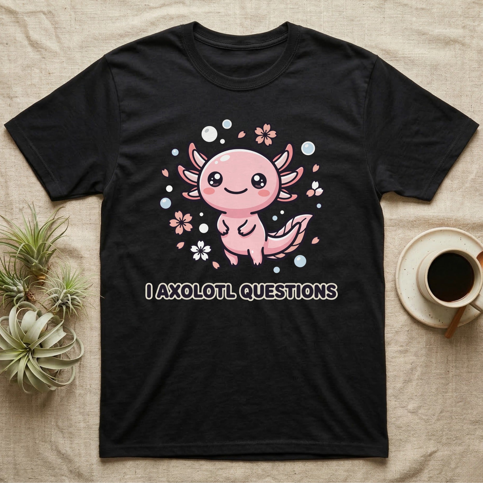 Black t-shirt with a smiling pink axolotl illustration and text "I AXOLOTL QUESTIONS".