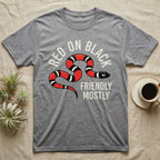 Milk Snake Friendly T-Shirt in Sport Grey — Worn screen-print of a red, black and cream banded milk snake under the cream words Red On Black, Friendly, Mostly