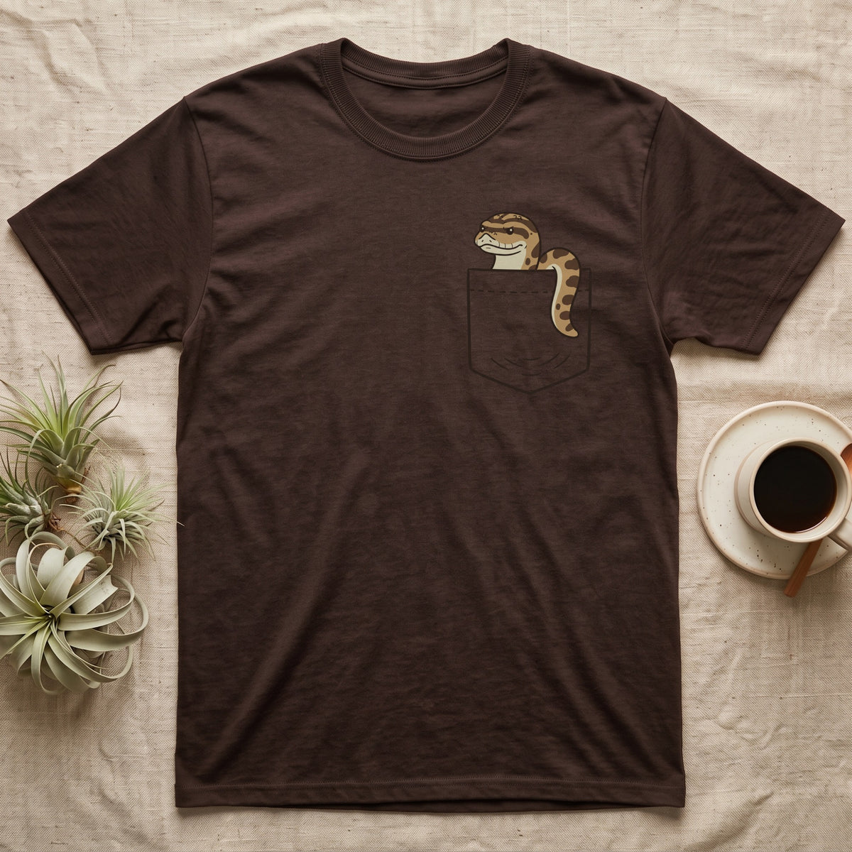 Hognose Pocket T-Shirt in Dark Chocolate — Cartoon western hognose with an upturned snout peeking out of a chest pocket, its body looped over the edge