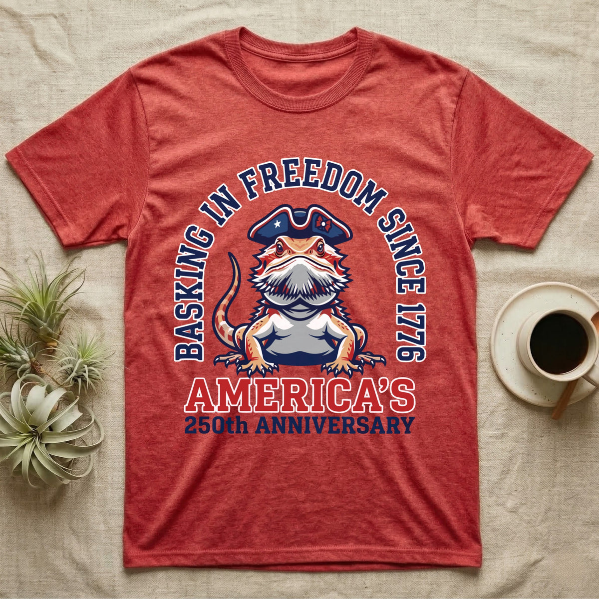 Bearded Dragon Basking T-Shirt in Heather Red — Sports-logo bearded dragon in a tricorn hat under a collegiate arch reading Basking in Freedom Since 1776.
