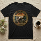 Black t-shirt with a circular graphic featuring a great white shark and "Wild Shark Club Pacific Coast" text.