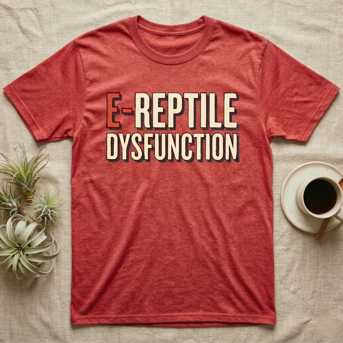 E-Reptile Dysfunction Gecko T-Shirt in Heather Red — Retro-pharmacy typographic wordmark reading "E-Reptile Dysfunction" in distressed cream and tomato-red lettering.