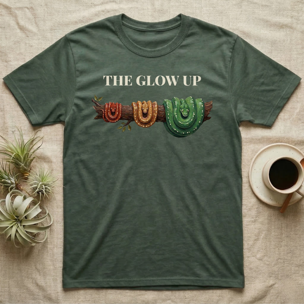 Green Tree Python Glow-Up T-Shirt in Military Green — Impasto illustration of a green tree python at three life stages on one branch: red hatchling, orange-brown subadult, green adult.