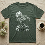 Jumping Spider Spooky Season T-Shirt in Military Green — Minimal continuous-line jumping spider over a spiderweb pumpkin, text "Spooky Season" with a spider in the O.
