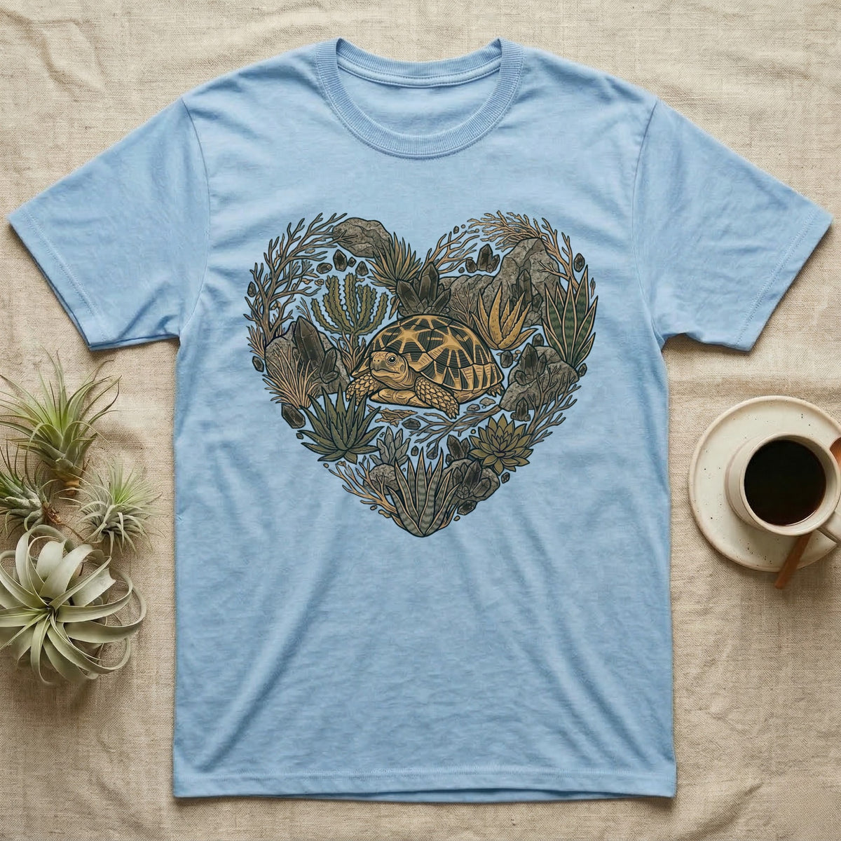 Light blue t-shirt with a heart-shaped succulent and turtle design.