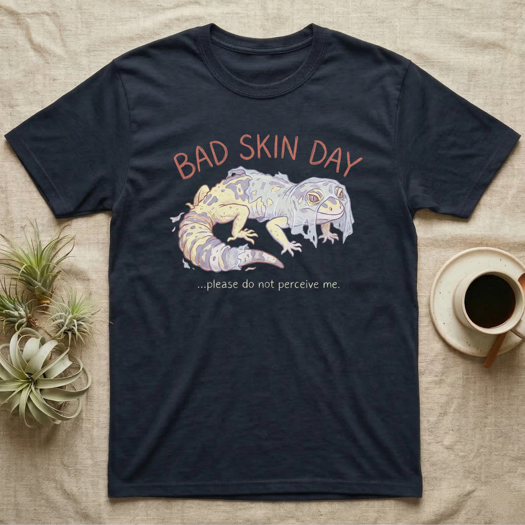 Dark t-shirt with "Bad Skin Day" and a shedding gecko illustration.