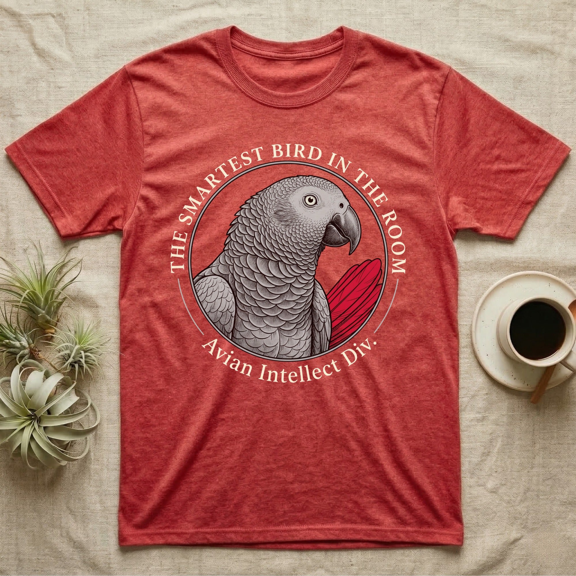 Red t-shirt with African Grey parrot graphic and text "The Smartest Bird in the Room".