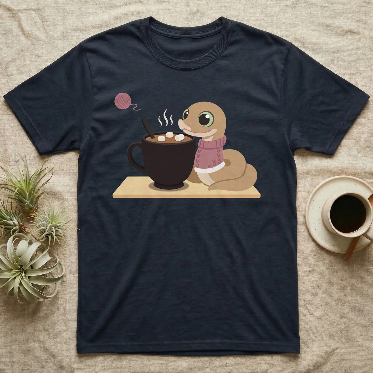 Hognose Snake Knitted Sweater T-Shirt in Navy — Soft-painted illustration of a hognose snake in a knitted jumper resting beside a mug of cocoa with marshmallows.
