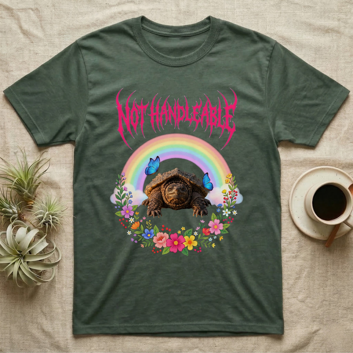 Snapping Turtle Hatchling T-Shirt in Military Green — Cute baby snapping turtle in a pastel rainbow and flower wreath under a hot pink metal logo reading NOT HANDLEABLE