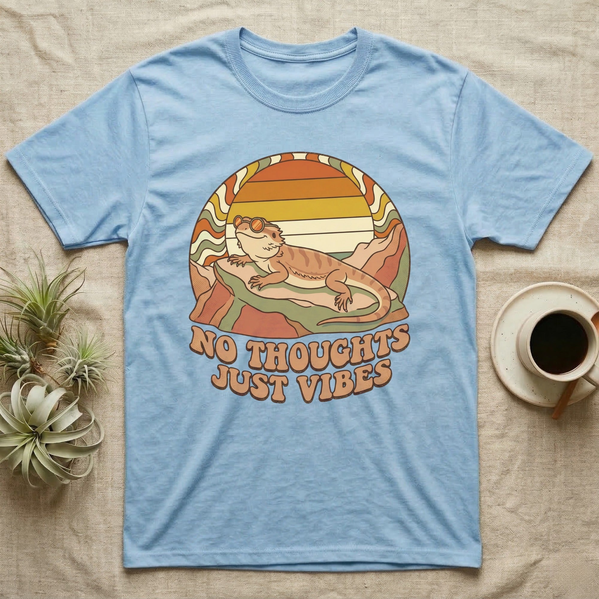 Light blue t-shirt with a bearded dragon wearing sunglasses, "No Thoughts Just Vibes" text.