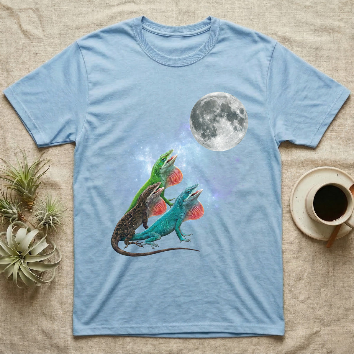 Green Anole Moon Howl T-Shirt in Light Blue — Three Green Anole colour morphs howling at a full moon over a nebula on a dark grey t-shirt.