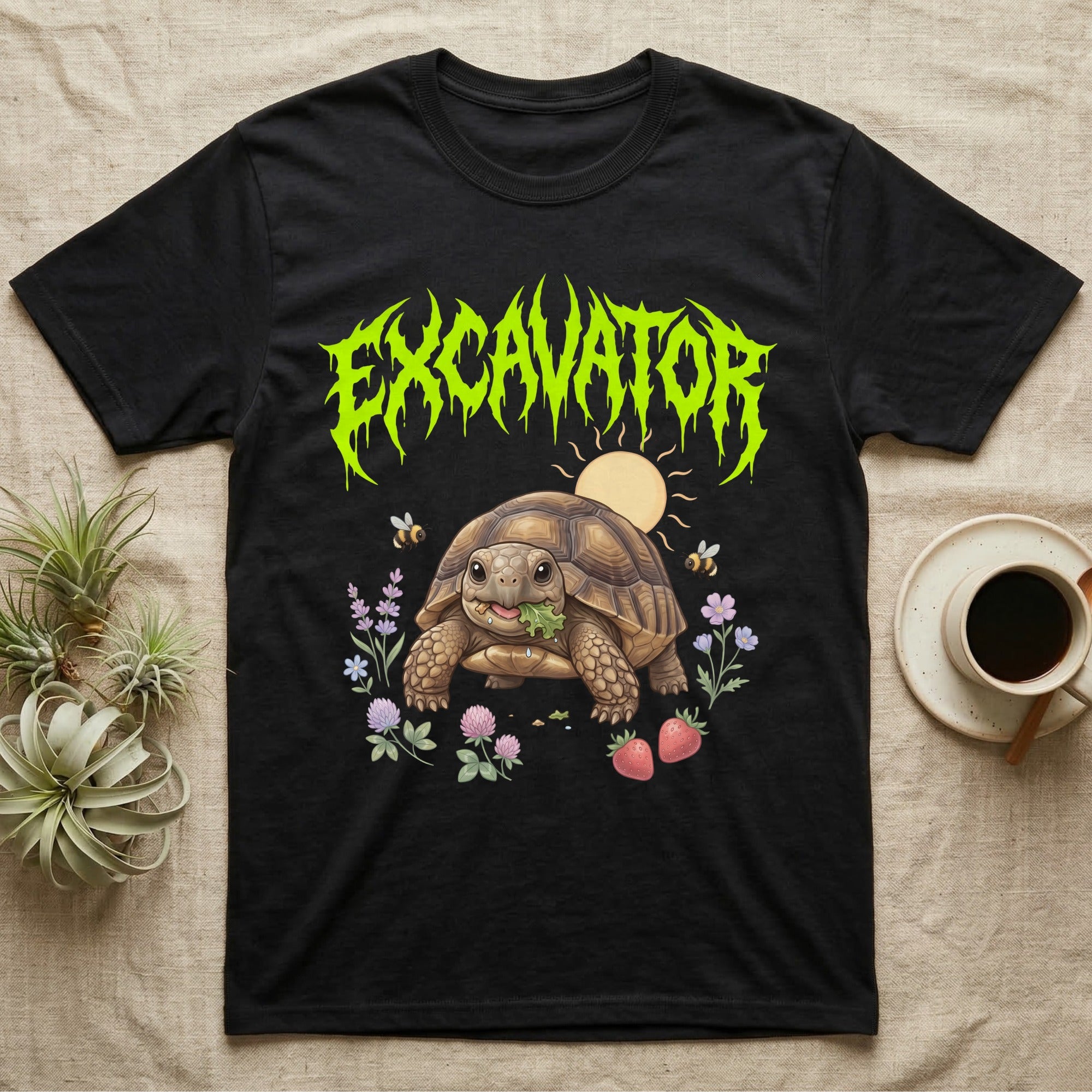 Russian Tortoise Feral T-Shirt in Black — Chubby Russian tortoise munching a green in a pastel meadow under a spiky lime metal wordmark reading EXCAVATOR.