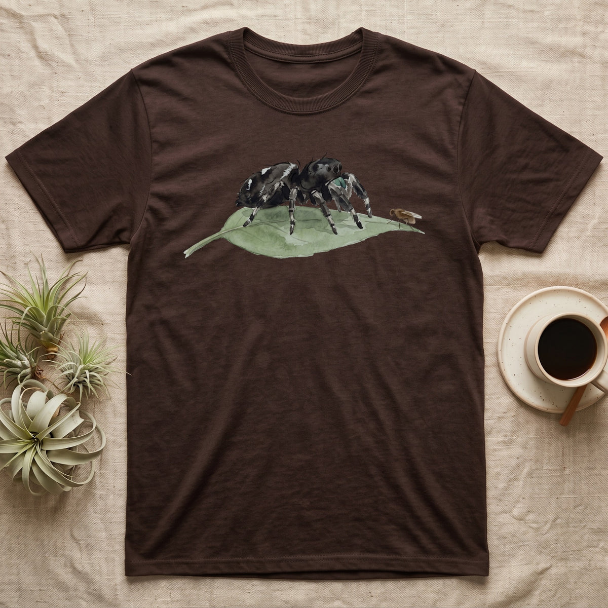 Jumping Spider Watercolour T-Shirt in Dark Chocolate — Watercolour regal jumping spider standing still on a green leaf, watching a single fruit fly perched on the leaf's tip.
