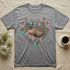 Gray t-shirt with a heart-shaped design of a Siamese cat, flowers, reeds, and blue gems.
