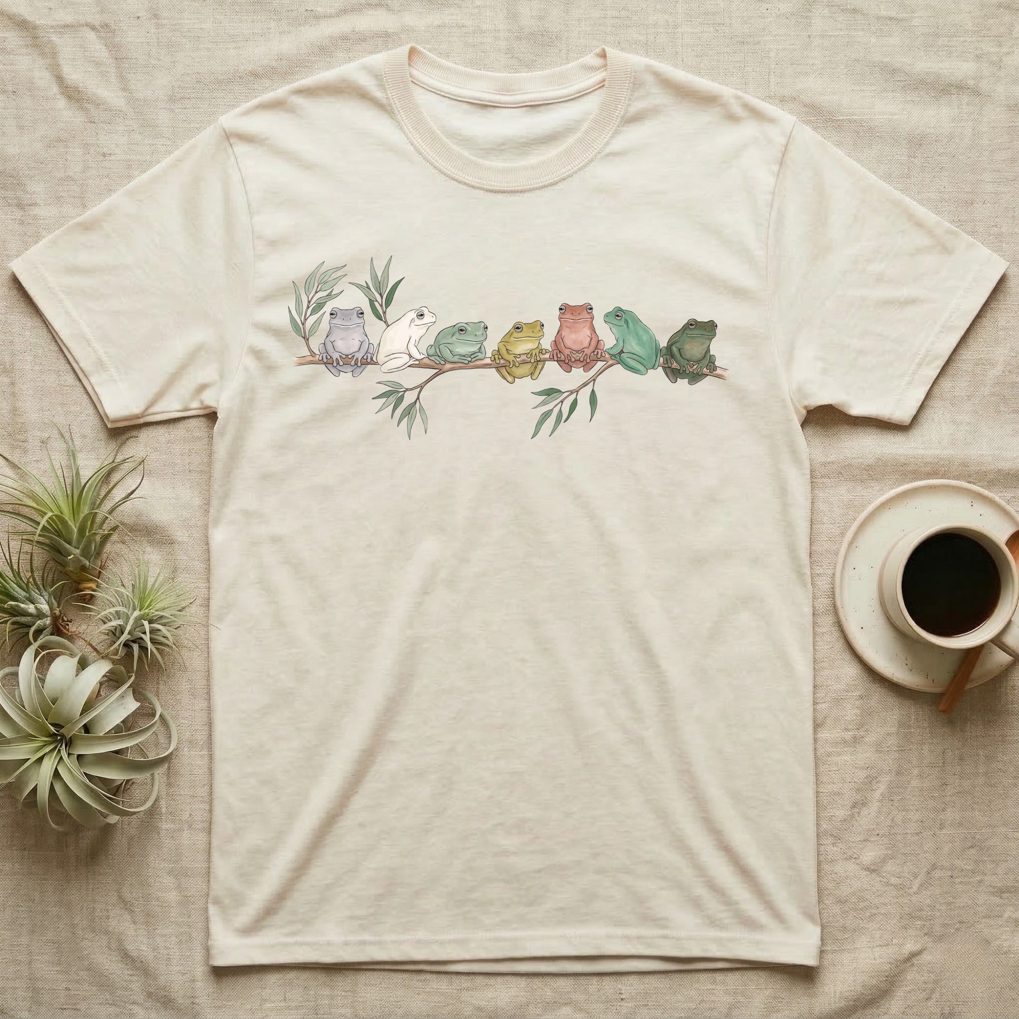 White's Tree Frog Canopy Crew T-Shirt in Natural — Watercolor illustration of seven White's tree frogs in different colour phases on a eucalyptus branch, dark grey T-shirt design.