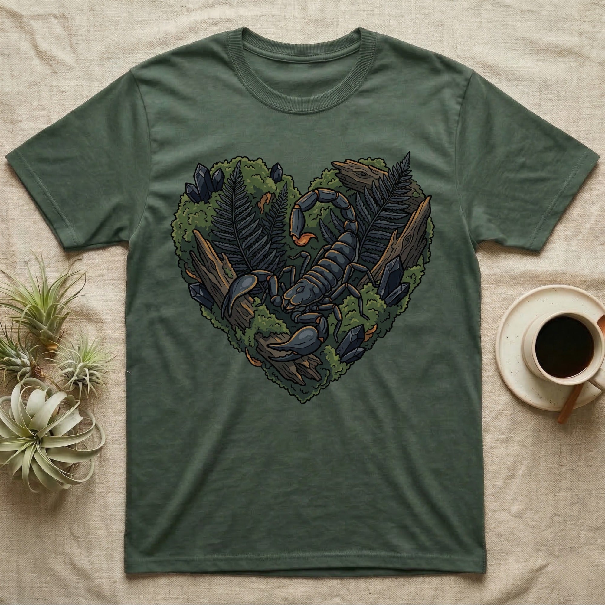Scorpion and foliage heart illustration on a green t-shirt.