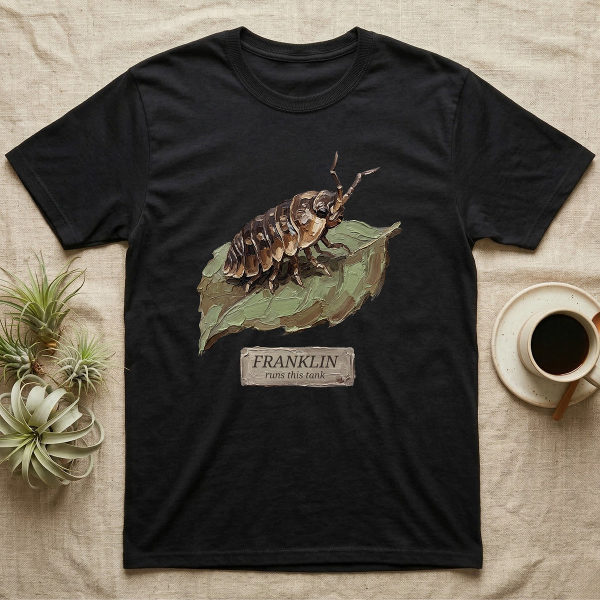 Franklin Isopod Tank T-Shirt in Black — Impasto oil-painting portrait of an isopod on a leaf with an engraved Franklin name-plate beneath the subject.