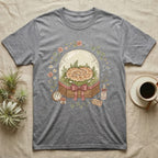 Grey t-shirt with a snake inside a glass dome, surrounded by flowers and the text "wrapped in love".