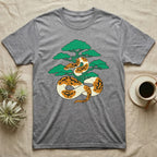 Grey t-shirt with a graphic of a patterned snake coiled around a bonsai tree.