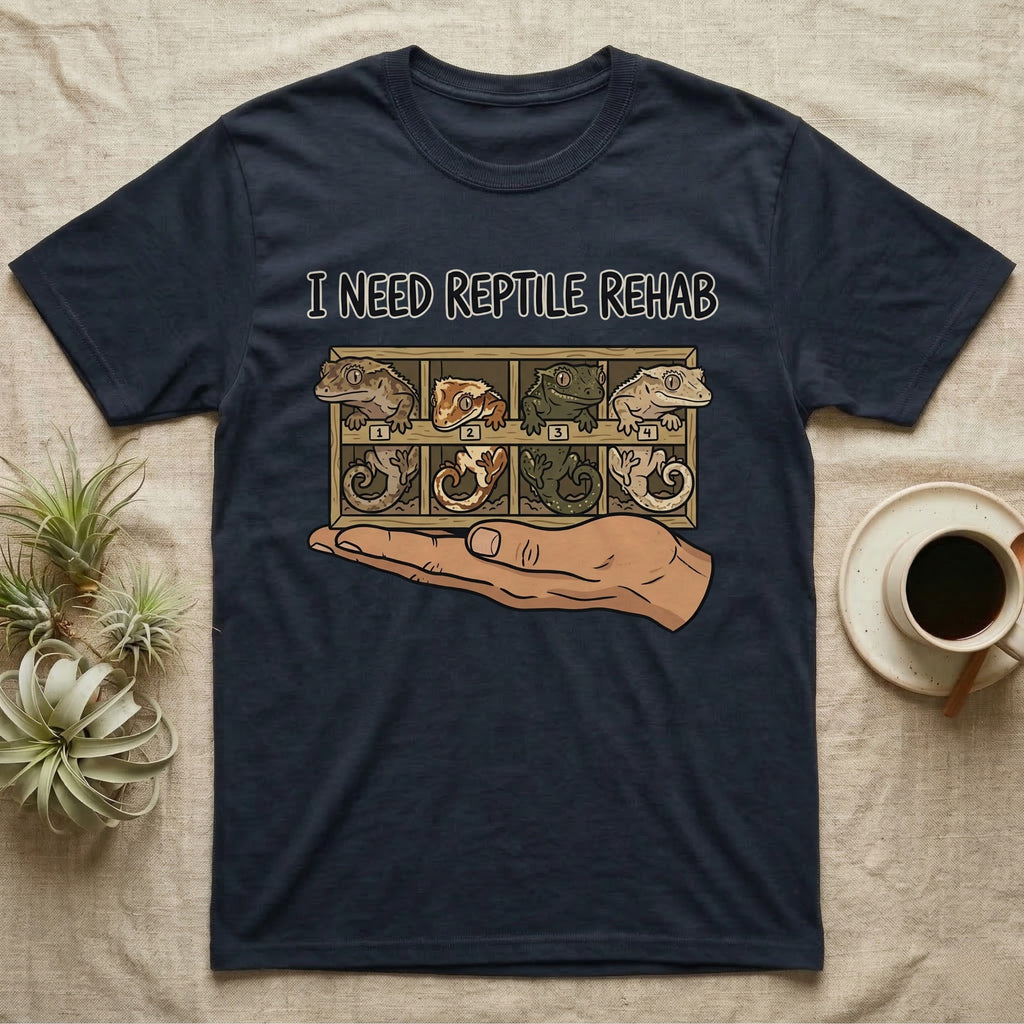 Crested Gecko Rehab T-Shirt in Navy — Vector scene of a hand presenting a rack of four crested geckos under a marker-style reptile rehab caption.