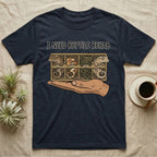 Crested Gecko Rehab T-Shirt in Navy — Vector scene of a hand presenting a rack of four crested geckos under a marker-style reptile rehab caption.