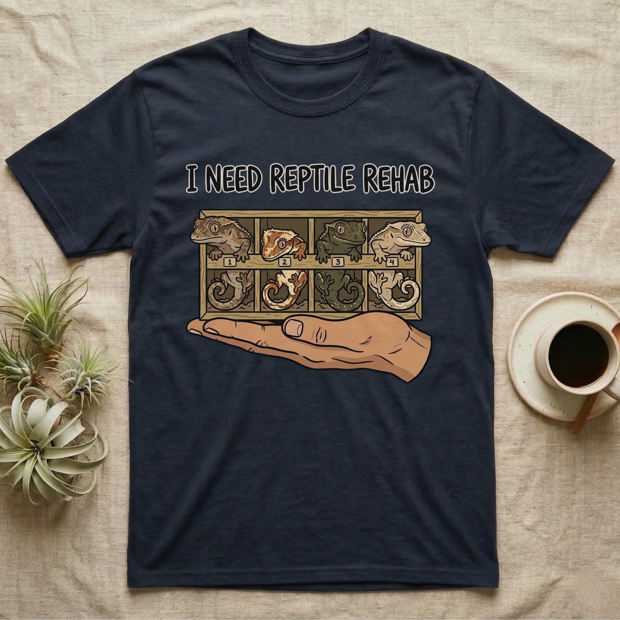 Crested Gecko Rehab T-Shirt in Navy — Vector scene of a hand presenting a rack of four crested geckos under a marker-style reptile rehab caption.