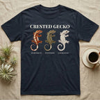 Crested Gecko Morph Chart T-Shirt in Navy — Impasto painted chart of three crested gecko morphs — harlequin, pinstripe and dalmatian — labelled beneath each gecko.