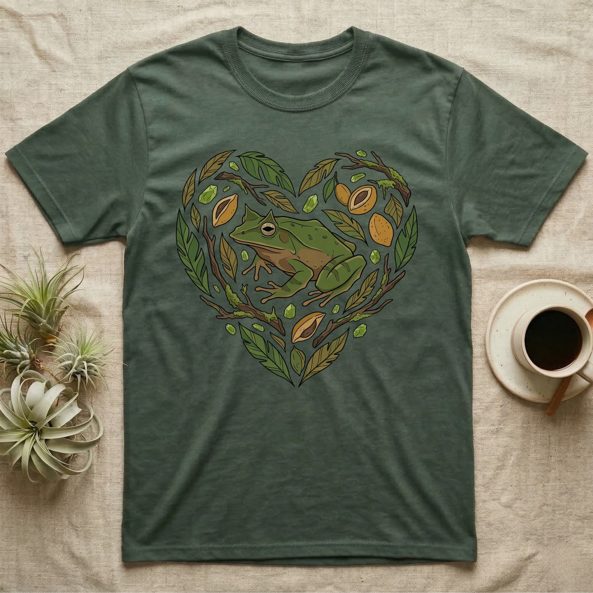 Green t-shirt with a heart design featuring a frog and natural elements.