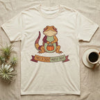 Bearded Dragon Mostly Treat T-Shirt in Natural — Patchwork-quilt bearded dragon holding a pumpkin pail, banner reading "Trick or Treat? Mostly Treat."