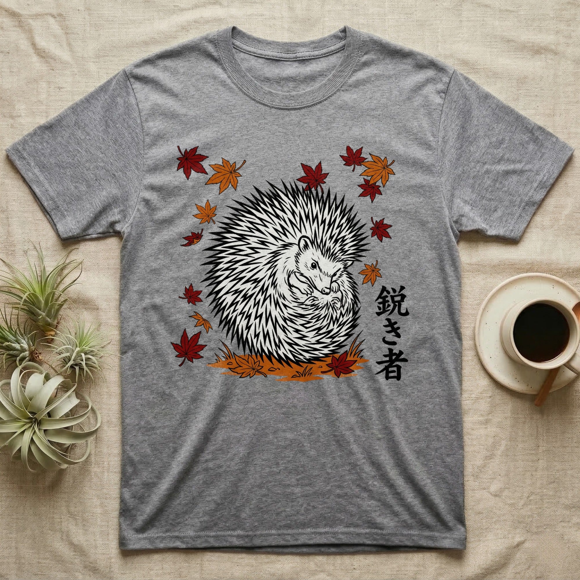 Grey t-shirt with a black and white hedgehog and autumn leaves design.